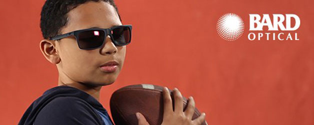 Boy wearing safety sunglasses while playing football