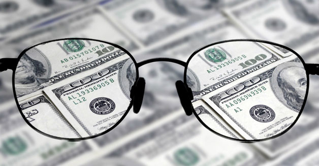 Glasses with money behind them