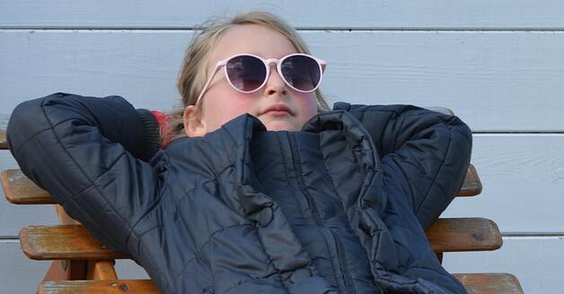 Child wearing sunglasses outside in the winter