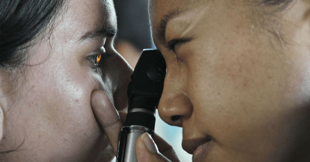 Eye doctor checking patient for diabetes