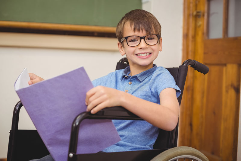 Child in wheel chair eyewearing glasses in peoria knoxville