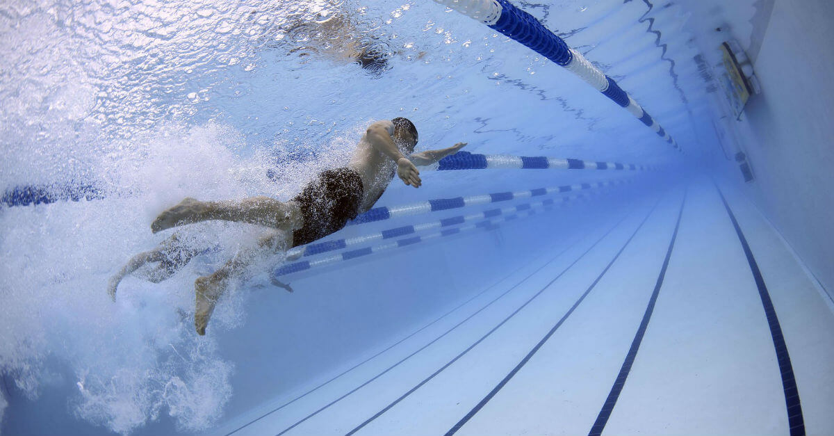 Man swimming in chlorine filled pool