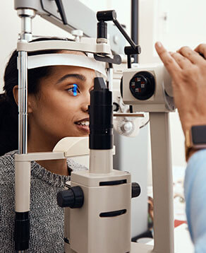 Woman undergoing a comprehensive eye health exam in Bard Optical Pekin