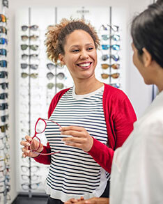Woman choosing eyeglasses in Bard Optical Decatur