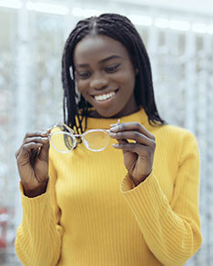 Woman holding a pair of eye glasses
