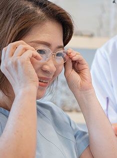 A woman trying on glasses in Bard Optical Pekin
