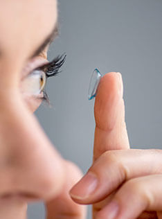 Woman putting contact lens