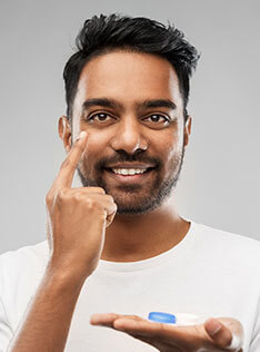 Man putting on contact lens