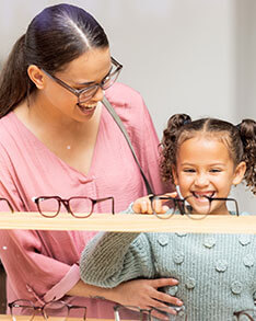 Mother and little girl choosing eyeglasses in Bard Optical Sterling