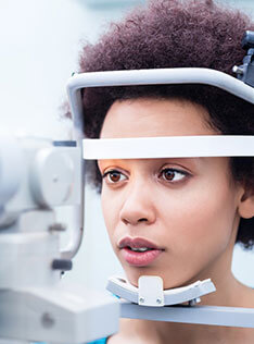 Woman undergoing contact lens exam in Bard Optical Washington