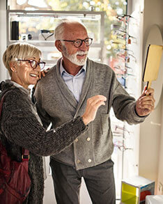 Couple trying on glasses in Bard Optical Washington