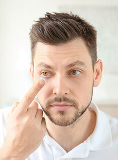 Man putting on contact lenses