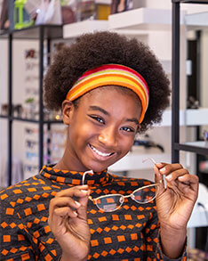 Girl smiling holding glasses