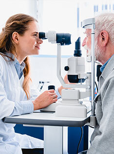 An elderly getting an eye exam at Bard Optical in Forsyth