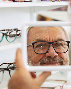 Man looking at the mirror wearing eyeglasses