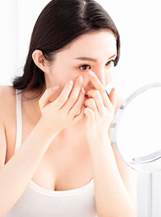 Woman putting on contact lens