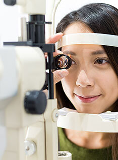 Woman getting an eye exam at Bard Optical in Normal