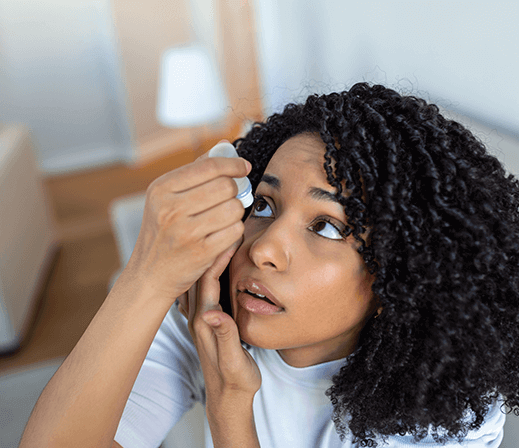 Woman applying eye drops for dry eyes